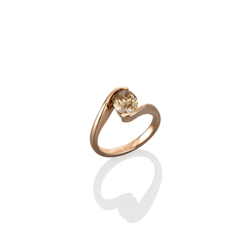 Gold dress ring with a diamond on a white background