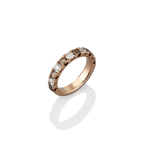 Gold ring with embedded argyle champagne and white diamonds on a white background shown from side view