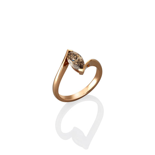 Rose gold ring with a brown gemstone on a white background