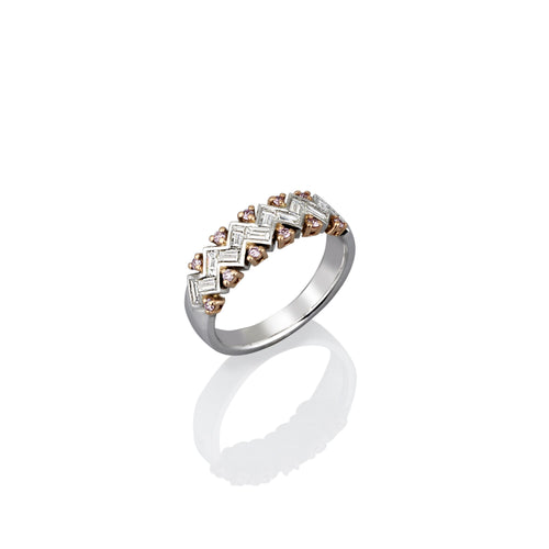 Gold ring with argyle pink diamond accents on a white background