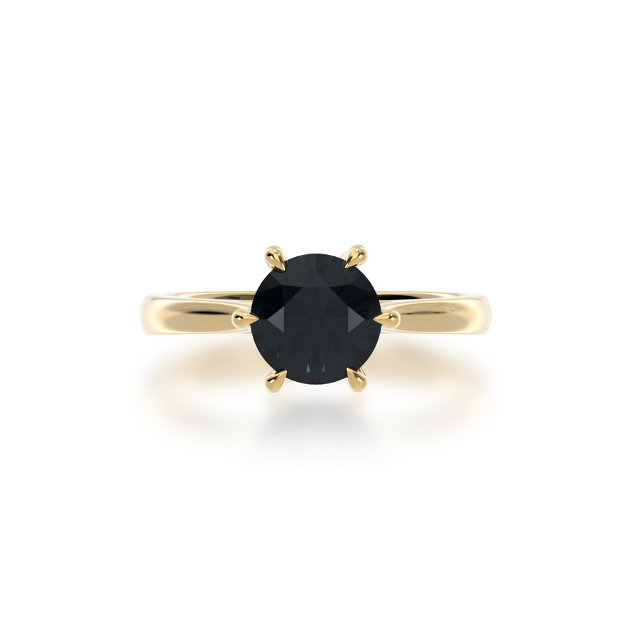 Brilliant cut black sapphire solitaire on a yellow gold band from top