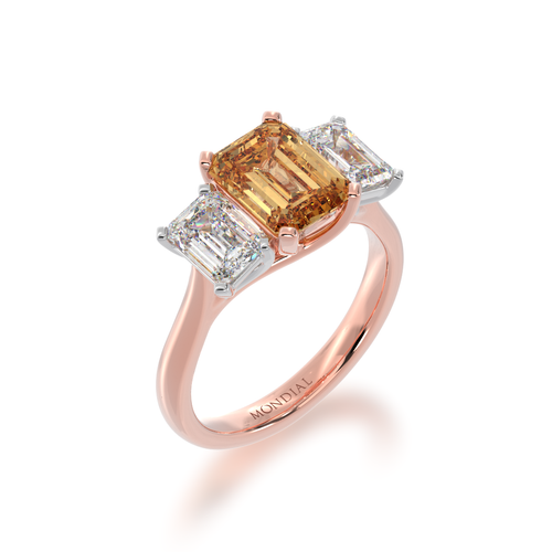 Trilogy emerald cut champagne and diamond ring on rose gold band view from angle