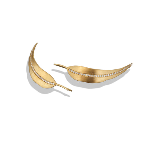 Gold leaf-shaped earrings with embedded white diamonds on a white background
