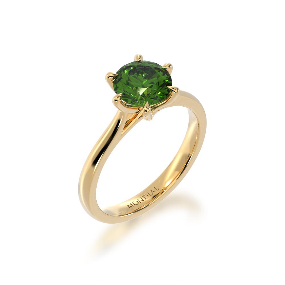 Brilliant cut green sapphire solitaire on a yellow gold band from angle