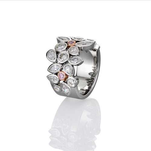 Side view of platinum ring showing white diamond accents and selected pink argyle diamonds on a white background