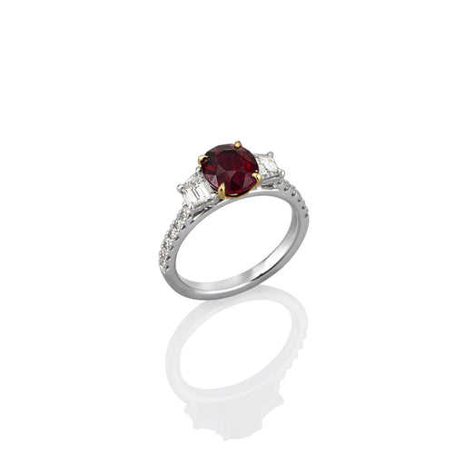 Oval Ruby white gold ring, set with white diamonds on the sides and around the band. photographed on white background and showing the side view.