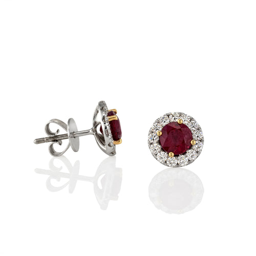 Pair of stud earrings with ruby gemstones and gold accents, showing side view