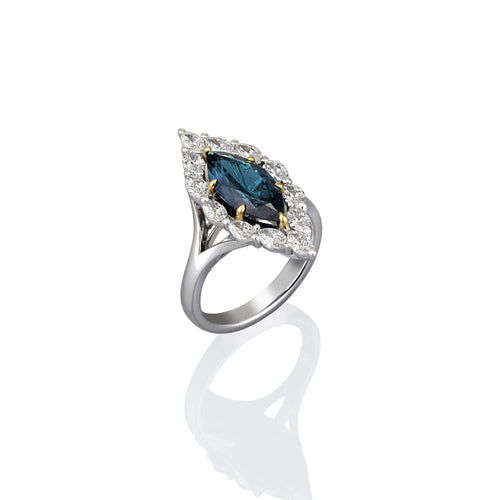 White gold ring with a blue gemstone on a white background