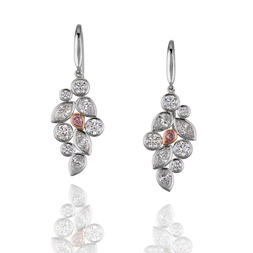 Pair of diamond earrings with rose gold accents on a white background