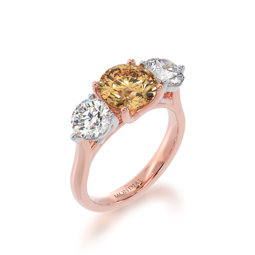 Trilogy round brilliant cut champagne and diamond ring on rose gold band view from angle