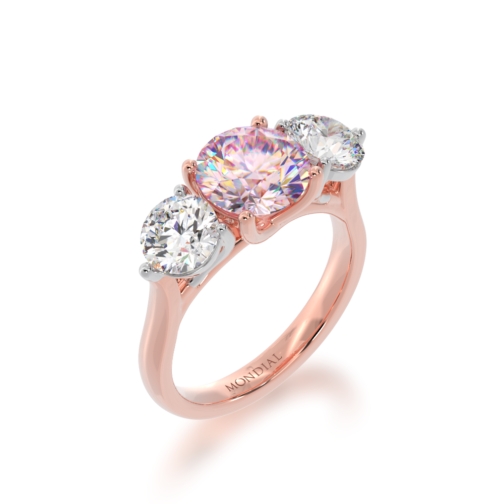 Trilogy round brilliant cut pink sapphire and diamond ring on rose gold band view from angle 