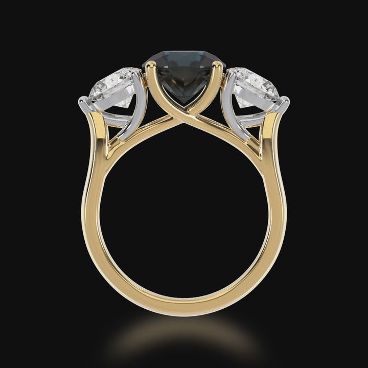 Trilogy round brilliant cut black sapphire and diamond ring on yellow band