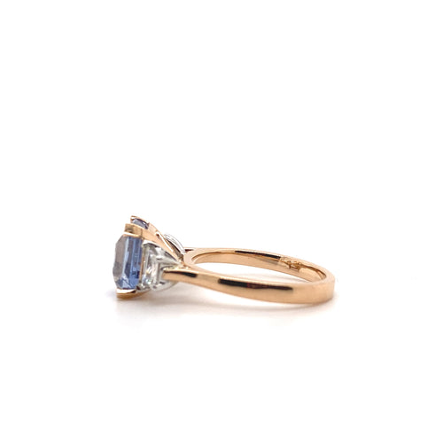 Side view of the Trilogy square cut blue sapphire engagement ring with diamonds on rose gold band by Mondial by Nadia.