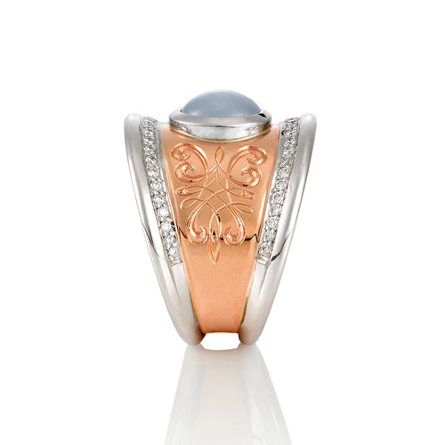 Side standing view of the Mondial by Nadia oval diamond ring with cabochon star sapphire diamond ring in rose and white gold.