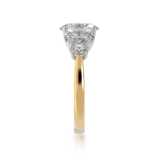 The Mondial by Nadia five stone oval diamond engagement ring on a yellow gold band from side.