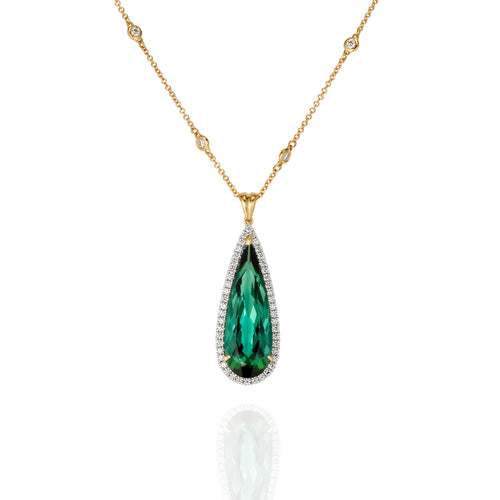 Elongated pear shaped green tourmaline and diamond pendant in yellow gold