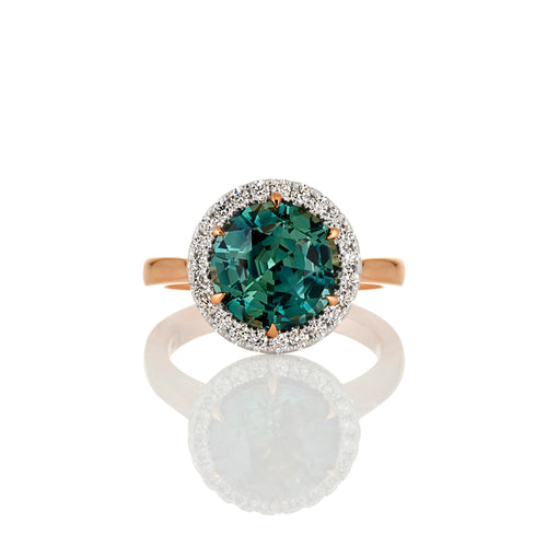 Round brilliant cut Australian teal sapphire and diamond halo design ring