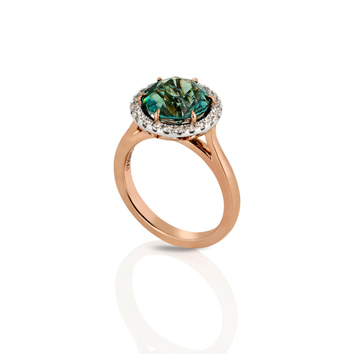 Round brilliant cut Australian teal sapphire and diamond halo design ring