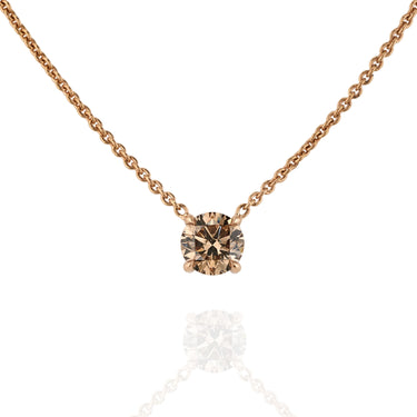 Gold necklace with a round champagne diamond pendant on a white background