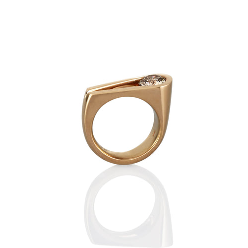 Contemporary gold engagement ring with an Argyle champagne diamond shown from a side view on a white background