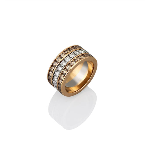 Gold ring with embedded white and argyle champagne diamonds on a white background