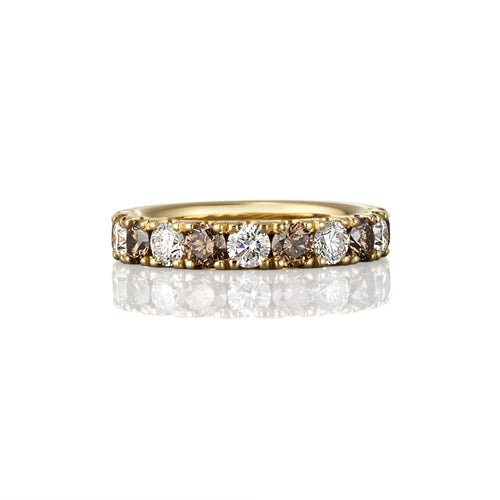 Gold ring with embedded argyle champagne and white diamonds on a white background