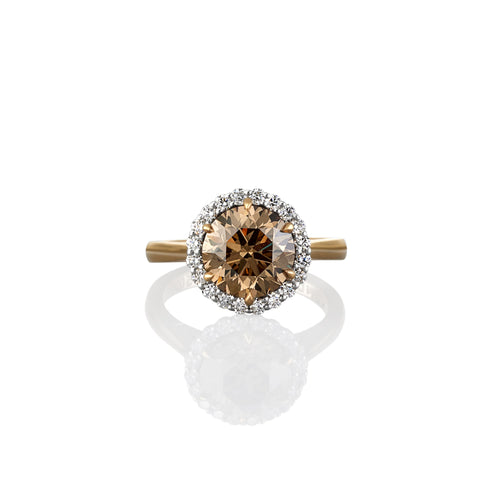 Gold ring with a central argyle champagne diamond and white diamond accents surrounding