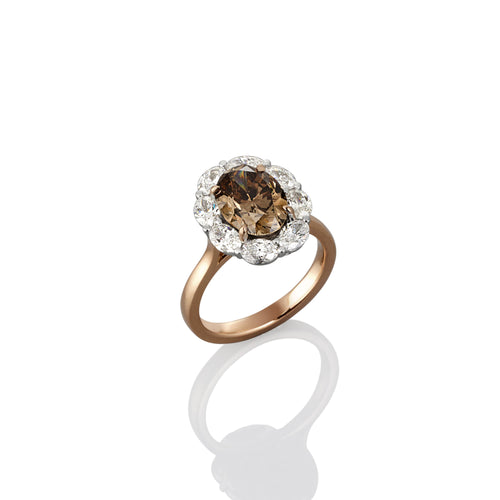 Gold ring with a central Argyle champagne diamond and surrounded with white diamond accents