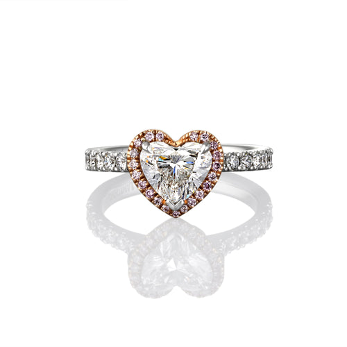 Heart-shaped diamond ring with gold band on a white background