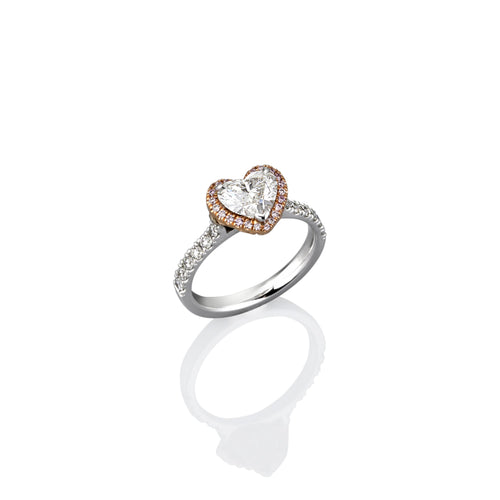 Heart-shaped diamond ring with gold on a white background