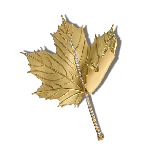 Gold autumn fold brooch with sparkling crystal accents on a white background.