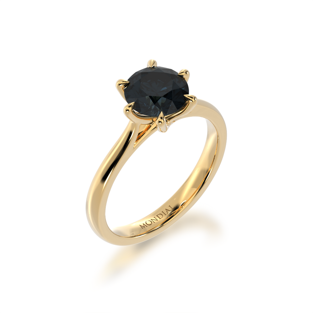 Brilliant cut black sapphire solitaire on a yellow gold band from angle