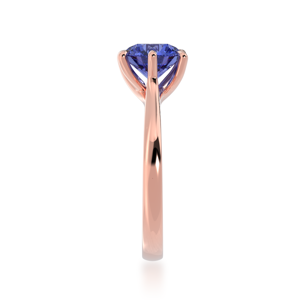 Brilliant cut blue sapphire solitaire on a rose gold band from side