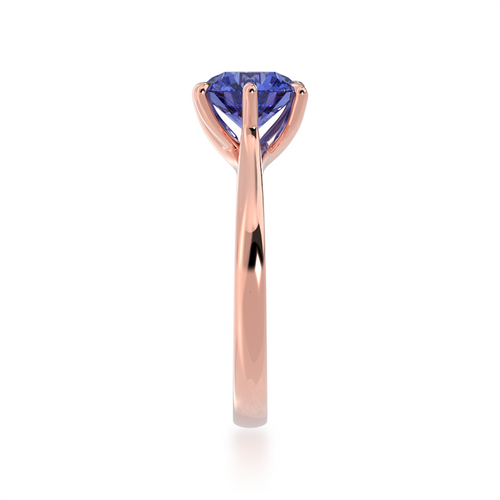 Brilliant cut blue sapphire engagement ring solitaire design on a rose gold band by Mondial by Nadia from side.