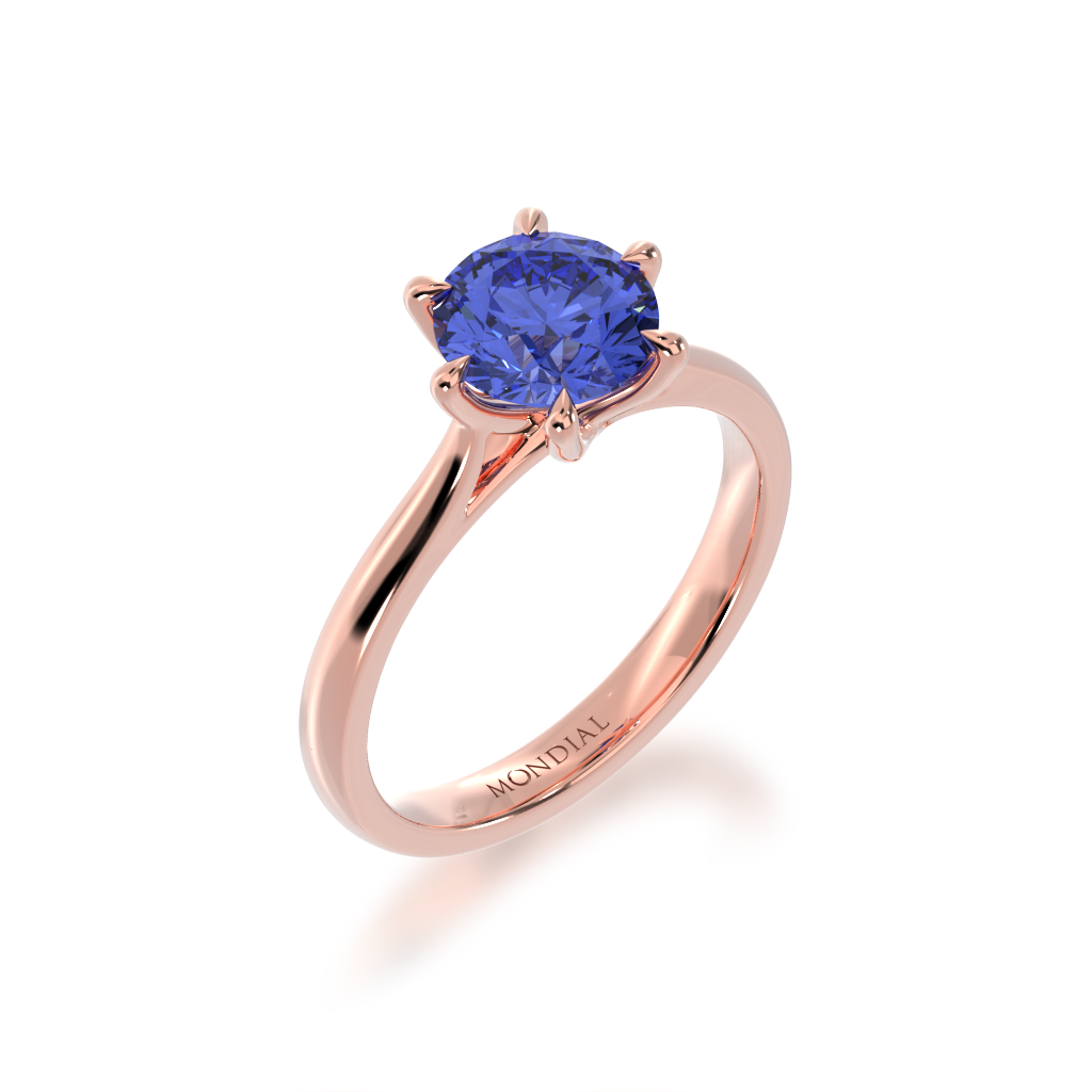 Brilliant cut blue sapphire solitaire on a rose gold band from angle