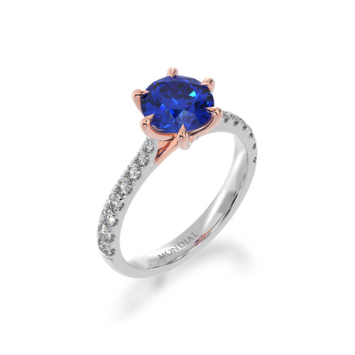 The Mondial by Nadia Round brilliant cut solitaire blue sapphire engagement ring with diamond set band view from angle.