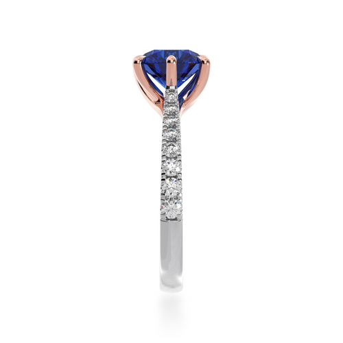 The Mondial by Nadia Round brilliant cut solitaire blue sapphire engagement ring with diamond set band view from side.