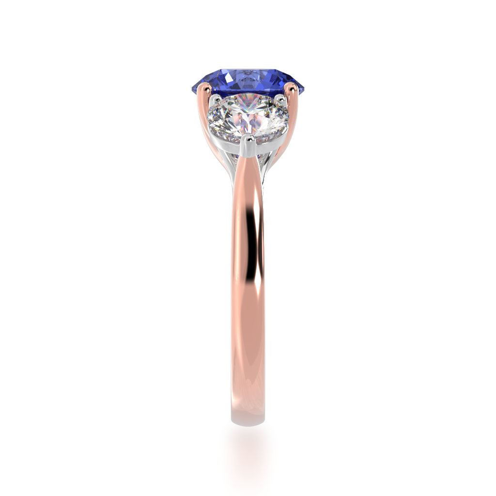 Round Brilliant cut trilogy blue Sapphire and Diamond ring on rose gold band view from side