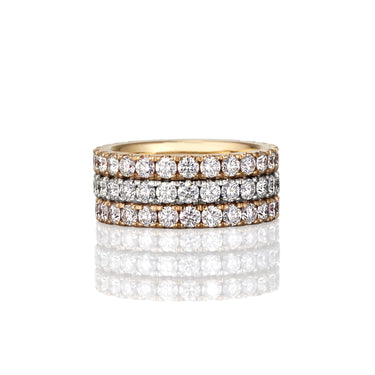 Three rows of white diamond on a thick banded gold eternity ring