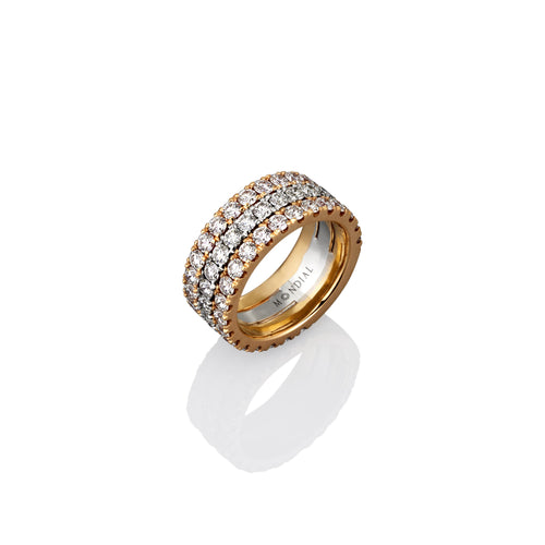 Three rows of white diamond on a thick banded gold eternity ring shot from the side view