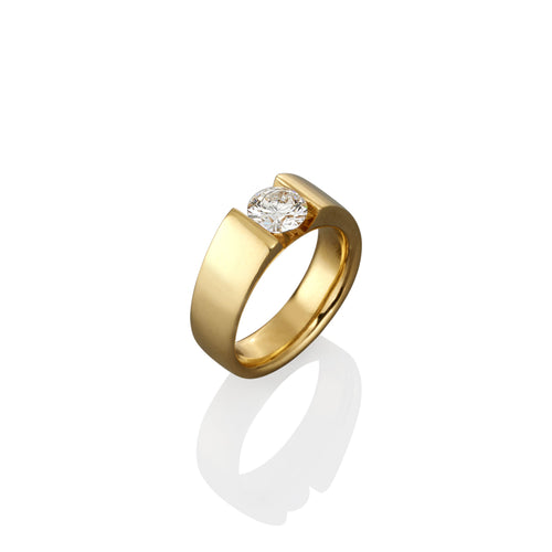 Gold ring with a brilliant cut white diamond on a white background