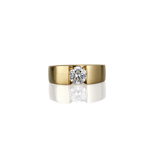 Gold ring with a single brilliant white diamond, showing the top of the ring aspect in the photograph