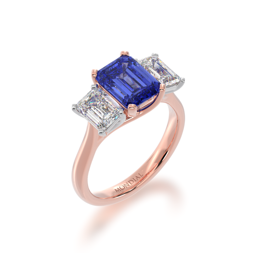 The Mondial by Nadia Trilogy emerald cut blue sapphire engagement ring with diamonds on rose gold band view from angle.