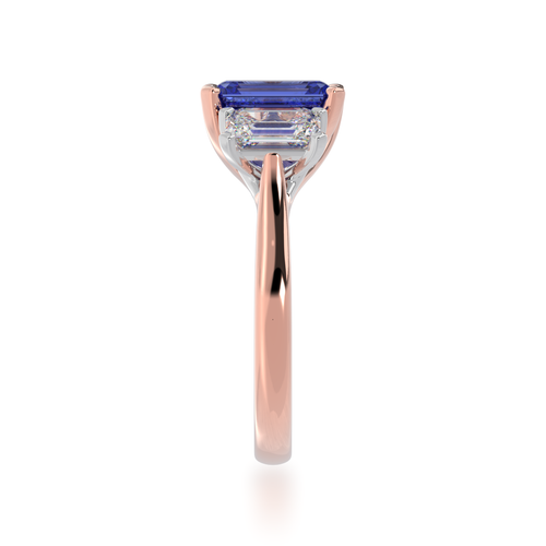 The Mondial by Nadia Trilogy emerald cut blue sapphire engagement ring with diamonds on rose gold band view from side.