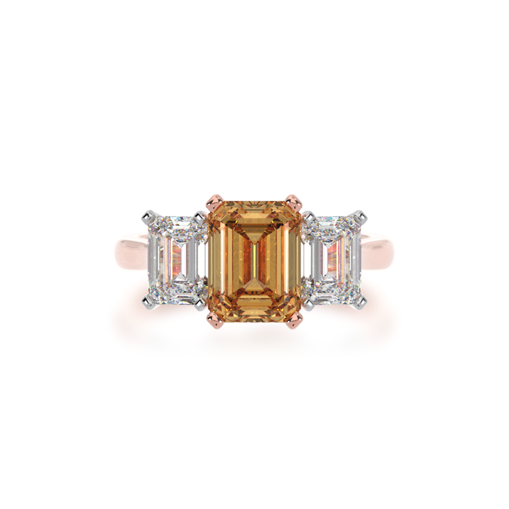 Trilogy emerald cut champagne and diamond ring on rose gold band view from top