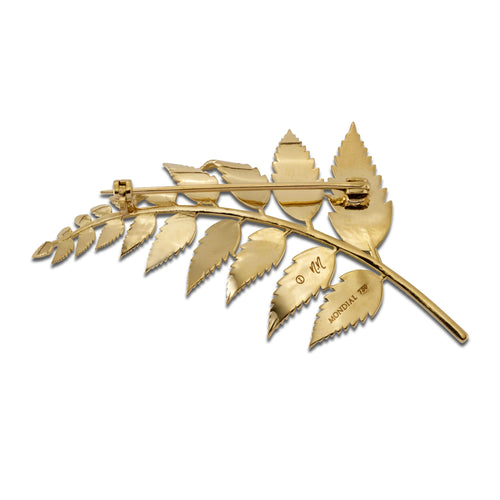 Back view of gold fern brooch showing the pin clasp on a white background.