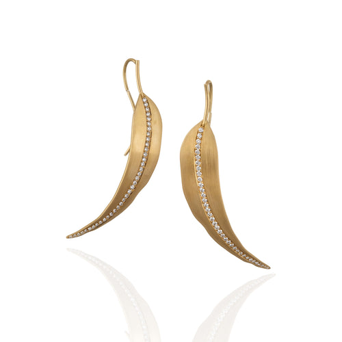 Gold leaf-shaped earrings with embedded white diamonds on a white background