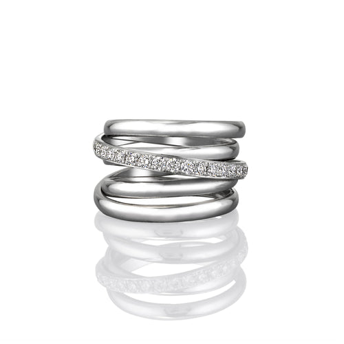 Stack of white gold rings with embedded row of white diamonds set on a white background