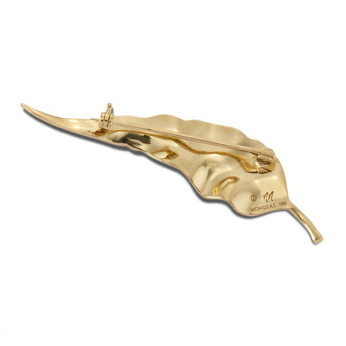 Back view of gold gum leaf brooch showing the pin clasp on a white background.
