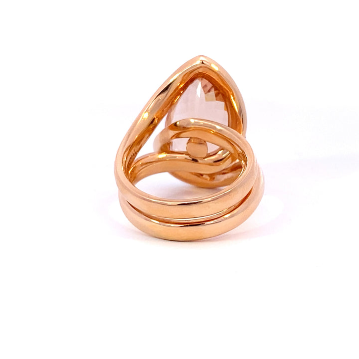 Pear shaped champagne peach coloured morganite ring in infinity design in rose gold view from back 